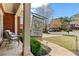 A picturesque front porch featuring comfortable seating and classic columns, with the Augusta Masters flag waving in the breeze at 8150 Albritton Downs, Cumming, GA 30041