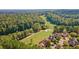 Picturesque aerial view of a golf course winding through a residential area, blending nature and community at 8150 Albritton Downs, Cumming, GA 30041
