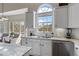 Bright kitchen features a stainless steel dishwasher, granite countertops, and white cabinets at 8150 Albritton Downs, Cumming, GA 30041