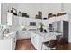Updated kitchen features white cabinets, an island with seating, stainless steel appliances, and granite countertops at 8150 Albritton Downs, Cumming, GA 30041