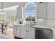Bright kitchen boasts a large window, stainless steel appliances, and stylish countertops at 8150 Albritton Downs, Cumming, GA 30041