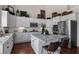 Kitchen featuring white cabinets, granite countertops, an island, and stainless steel appliances at 8150 Albritton Downs, Cumming, GA 30041