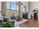 Bright living room boasts soaring windows, fireplace, hardwood floors, and open access to the kitchen at 8150 Albritton Downs, Cumming, GA 30041