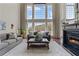 Spacious living room with fireplace and large windows, providing natural light and inviting views at 8150 Albritton Downs, Cumming, GA 30041