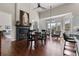 Bright living room featuring fireplace with horse art, seating area, and dark hardwood flooring at 8150 Albritton Downs, Cumming, GA 30041