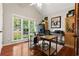 Bright home office with hardwood floors, a large window with a view, and ample workspace for productivity at 8150 Albritton Downs, Cumming, GA 30041
