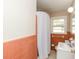 Bathroom shows salmon colored tile, a white vanity, and a window with a shower curtain at 6251 Pisgah Sw Rd, Mableton, GA 30126