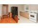 A compact kitchen includes a dining table, black refrigerator, and white range and oven at 6251 Pisgah Sw Rd, Mableton, GA 30126