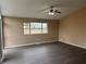 Living room with gray vinyl flooring and a large window at 2764 Plantation Dr, East Point, GA 30344