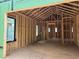 Interior shot of an unfinished home with exposed beams and framing, featuring black framed windows at 170 Cedarwood Ln, Roswell, GA 30075