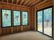 View of the framed space that will become the living room showcasing large black-framed windows at 170 Cedarwood Ln, Roswell, GA 30075