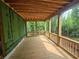 Spacious screened porch with wood flooring and ceiling overlooking a lush backyard at 170 Cedarwood Ln, Roswell, GA 30075