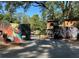 Unique backyard entrance with painted fence and playhouses under a canopy of trees at 3380 Lake Valley Nw Rd, Atlanta, GA 30331