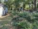 Backyard featuring lush greenery and mature trees with an adjacent house at 3380 Lake Valley Nw Rd, Atlanta, GA 30331
