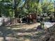 A treehouse in the backyard with a lush green space and seating area beneath at 3380 Lake Valley Nw Rd, Atlanta, GA 30331
