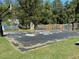 A basketball court with graffiti and bleacher seating in a backyard setting at 3380 Lake Valley Nw Rd, Atlanta, GA 30331