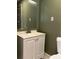 Simple bathroom with a white vanity, sink, and standard toilet at 3380 Lake Valley Nw Rd, Atlanta, GA 30331