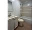 Clean bathroom features a white vanity, and a shower-tub combination with tiled surround at 3380 Lake Valley Nw Rd, Atlanta, GA 30331