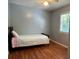 Cozy bedroom featuring hardwood floors, a ceiling fan, and natural light from a window at 3380 Lake Valley Nw Rd, Atlanta, GA 30331