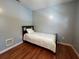 Modest bedroom with wood floors, light-blue walls, and a single bed at 3380 Lake Valley Nw Rd, Atlanta, GA 30331