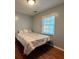 Cozy bedroom with neutral walls, hardwood floors, and a window for natural light at 3380 Lake Valley Nw Rd, Atlanta, GA 30331