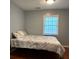 Comfortable bedroom featuring hardwood floors, natural light and a cozy comforter at 3380 Lake Valley Nw Rd, Atlanta, GA 30331