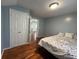 Bright bedroom featuring hardwood floors and a double closet for storage at 3380 Lake Valley Nw Rd, Atlanta, GA 30331
