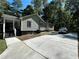 Exterior view of the house showcasing ample parking space and access to the backyard at 3380 Lake Valley Nw Rd, Atlanta, GA 30331