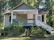 The house boasts a charming front porch with white railings, perfect for relaxing outdoors at 3380 Lake Valley Nw Rd, Atlanta, GA 30331
