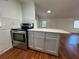 Kitchen featuring stainless steel appliances, a white countertop island, and hardwood floors at 3380 Lake Valley Nw Rd, Atlanta, GA 30331