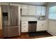 Modern kitchen with stainless steel appliances, white cabinets, and subway tile backsplash at 3380 Lake Valley Nw Rd, Atlanta, GA 30331