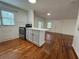 Kitchen features a modern island, stainless steel appliances, white cabinets, and hardwood floors at 3380 Lake Valley Nw Rd, Atlanta, GA 30331