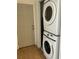 Convenient laundry area with stacked washer and dryer, located near an exterior door at 3380 Lake Valley Nw Rd, Atlanta, GA 30331