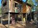 A rustic elevated treehouse with a ladder entrance in a whimsical backyard setting at 3380 Lake Valley Nw Rd, Atlanta, GA 30331