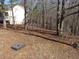 View of the spacious backyard bordered by mature trees at 434 Spring Leaf Dr, Dallas, GA 30157