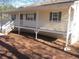 Charming exterior of home featuring a large porch with white railings at 434 Spring Leaf Dr, Dallas, GA 30157