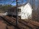 Exterior view of a home with a large porch, nestled among the trees at 434 Spring Leaf Dr, Dallas, GA 30157