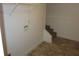 Unfinished laundry room featuring laminate flooring, water connections, and storage shelves at 434 Spring Leaf Dr, Dallas, GA 30157
