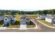 Aerial view of a grey two-story home featuring a two car garage, landscaping, sidewalks and green spaces at 1857 Holmsey Cir, Conyers, GA 30094