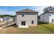 Backyard of a two story home featuring a grass lawn, and small concrete patio at 1857 Holmsey Cir, Conyers, GA 30094