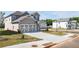 Two-story home with a two-car garage, covered front entry, and sidewalk at 1857 Holmsey Cir, Conyers, GA 30094