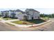Corner lot home featuring a two car garage, covered entry, sidewalks and a manicured lawn at 1857 Holmsey Cir, Conyers, GA 30094