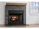 Modern fireplace with stone surround and hardwood floor at 377 Anders N, Chattahoochee Hills, GA 30268