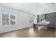 Modern kitchen with gray cabinets and hardwood floors at 377 Anders N, Chattahoochee Hills, GA 30268