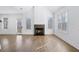 Sunlit living room showcasing hardwood floors and fireplace at 377 Anders N, Chattahoochee Hills, GA 30268