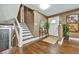 Inviting home entryway with a staircase and an elegant mirror, enhancing the home's warm and welcoming ambiance at 2953 Collier Nw Dr, Atlanta, GA 30318