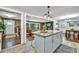 Stylish kitchen island seamlessly connects to the living room with stone fireplace and adjacent dining area at 2953 Collier Nw Dr, Atlanta, GA 30318