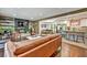 Open-concept living room with a modern fireplace, view of kitchen and dining area, and hardwood floors at 2953 Collier Nw Dr, Atlanta, GA 30318