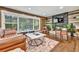 Inviting living room featuring hardwood floors, a stone fireplace, and large window providing ample natural light at 2953 Collier Nw Dr, Atlanta, GA 30318