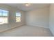 Bedroom with natural lighting, plush carpet and views from two large windows at 125 Belvedere Rd, Mcdonough, GA 30253